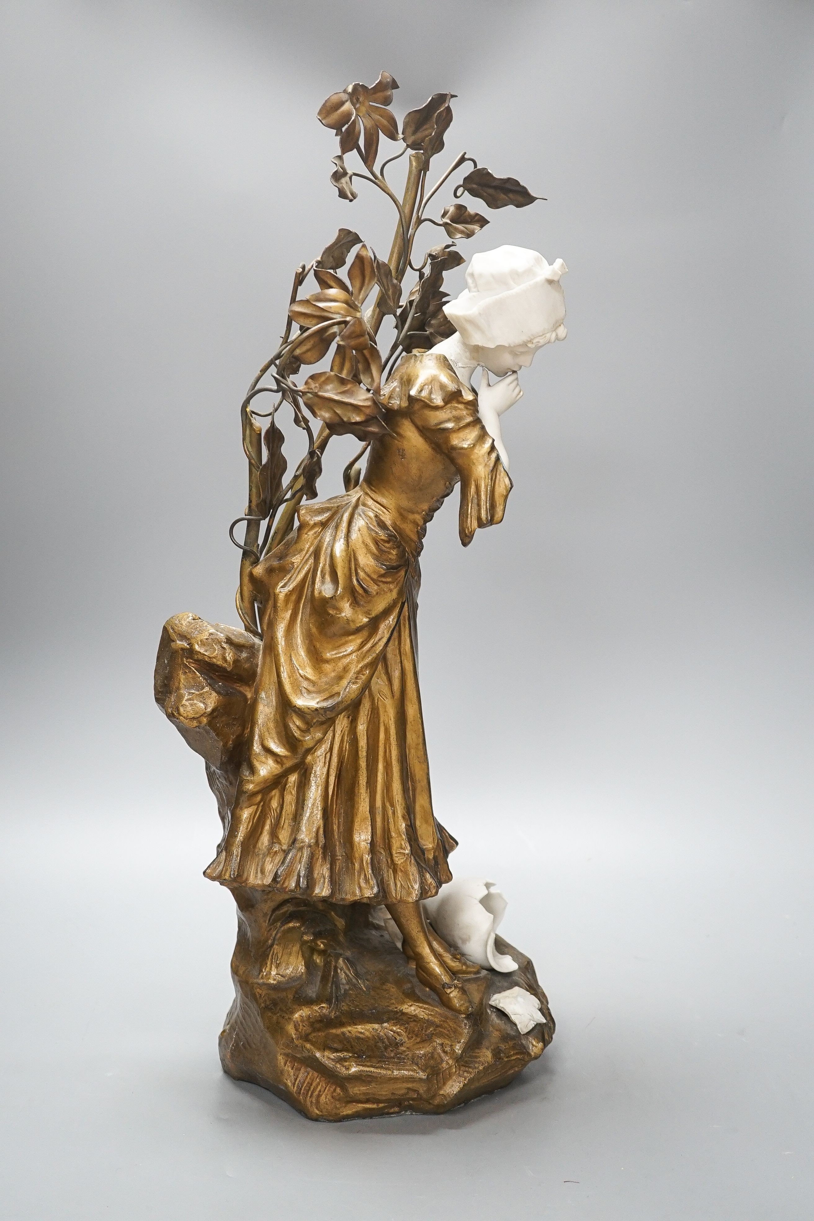 A late 19th Century French gilt spelter and bisque porcelain figure after Mednat 54cm